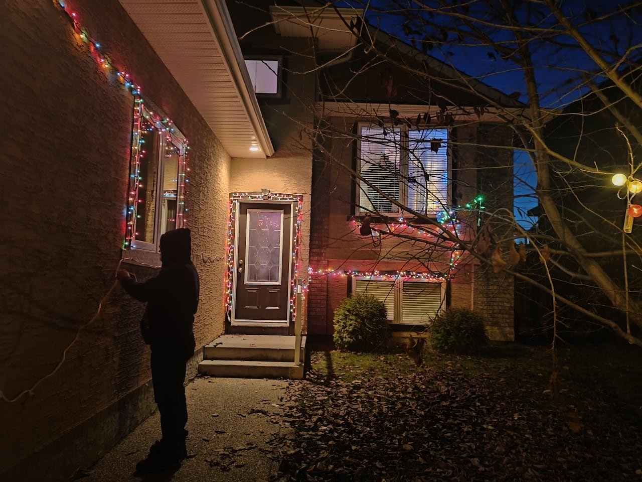 default-490 Lights sparkle on the edges of a house lit at night.